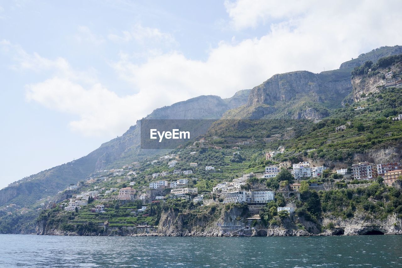 Scenic view of sea and mountains against sky