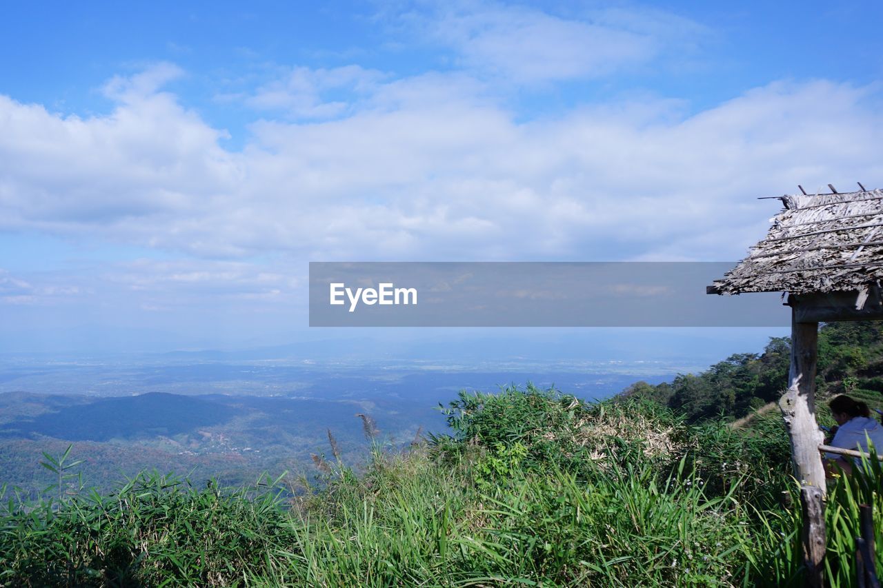 Scenic view of landscape by sea against sky