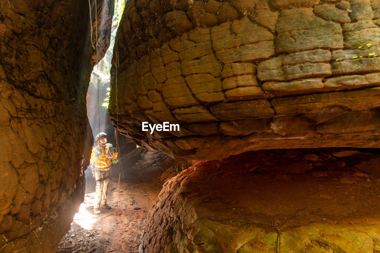 Full length of woman standing in cave