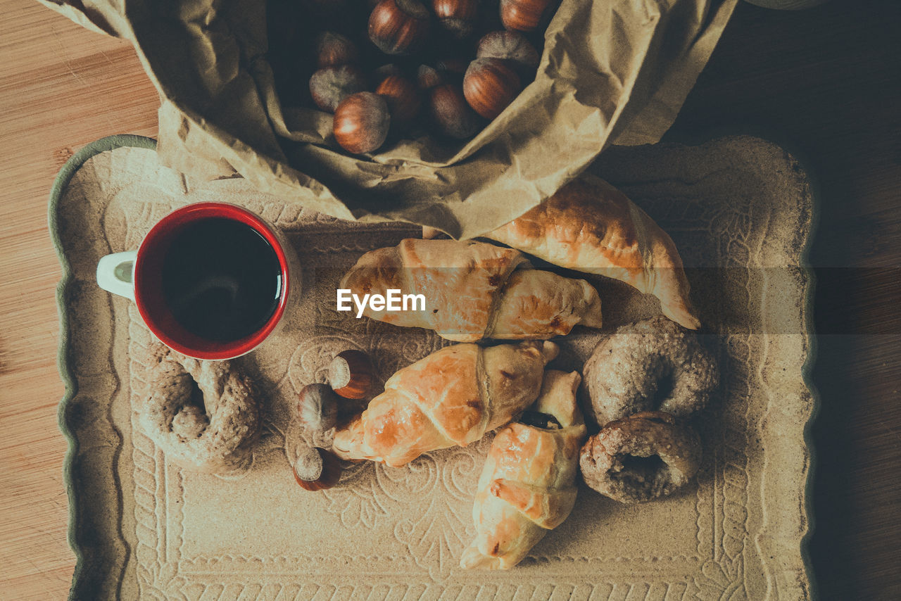 HIGH ANGLE VIEW OF ROASTED COFFEE WITH CUP AND SPOON