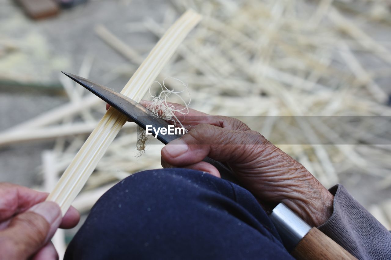 Close-up of hand making craft product