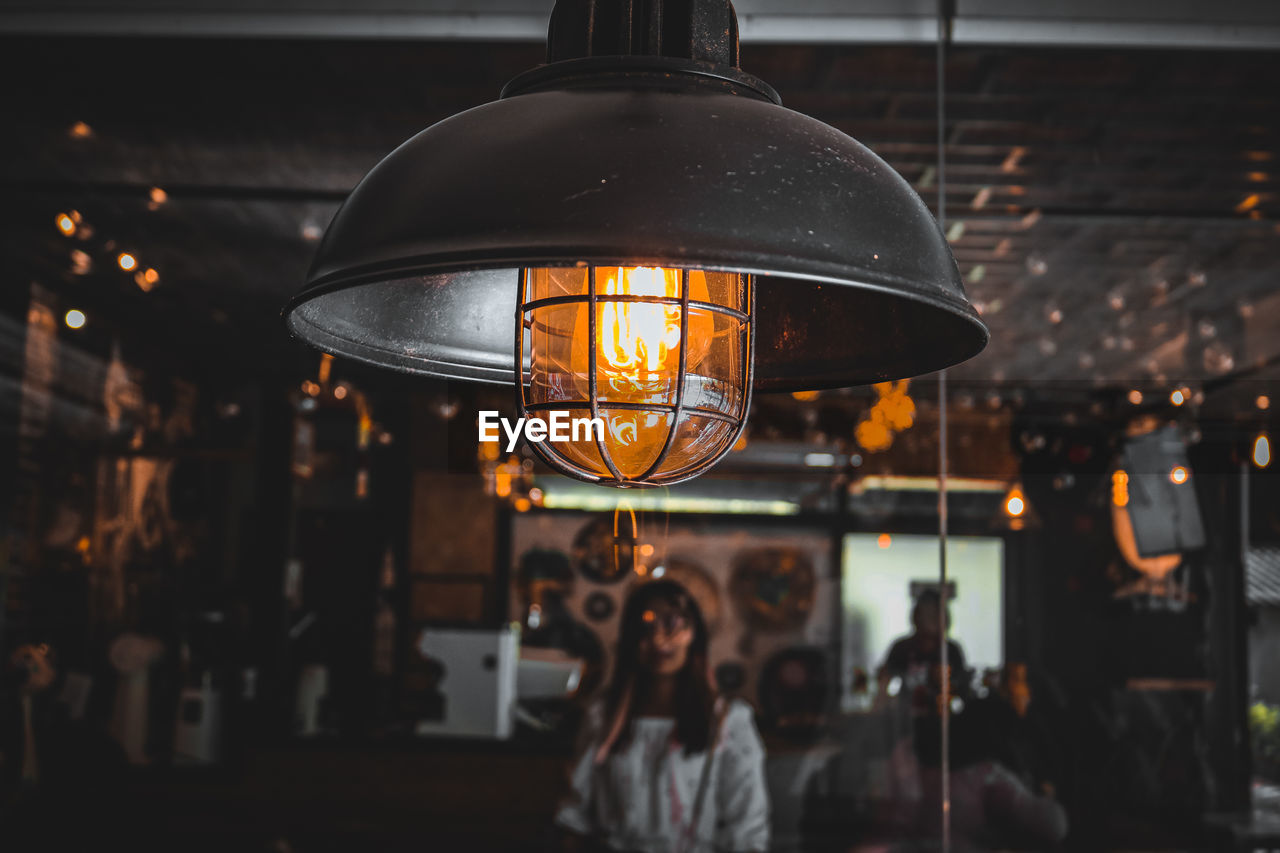 Close-up of illuminated pendant lights hanging at night