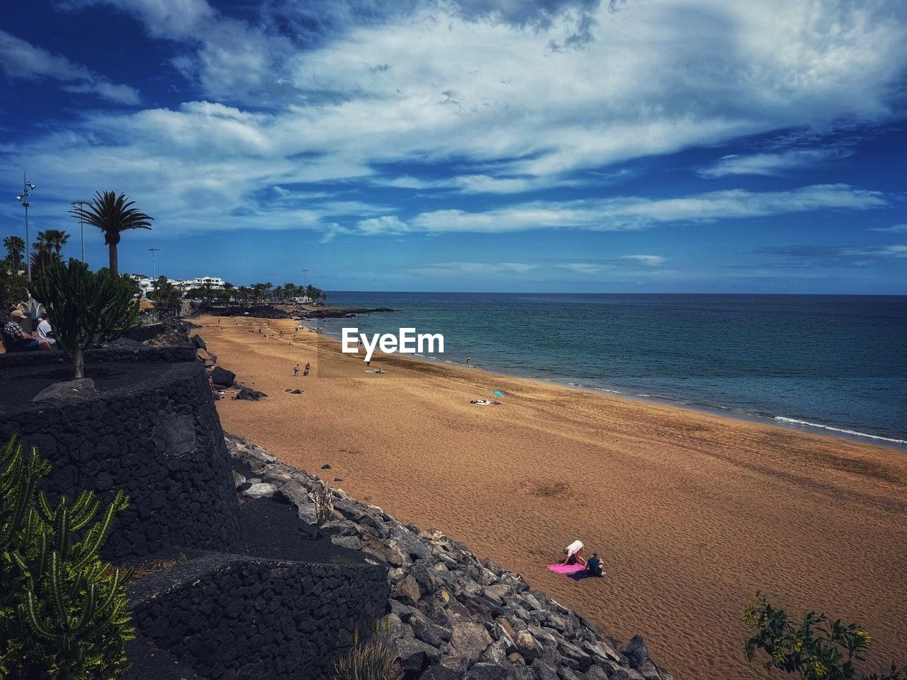 beach, sea, land, sky, water, ocean, cloud, nature, sand, horizon, coast, shore, body of water, beauty in nature, scenics - nature, plant, tropical climate, palm tree, tree, holiday, tranquility, travel destinations, vacation, horizon over water, trip, tranquil scene, travel, coastline, wave, bay, tourism, outdoors, dusk, idyllic, environment, day, blue, coconut palm tree, tropics, relaxation, island, summer, landscape, sunset, sunlight