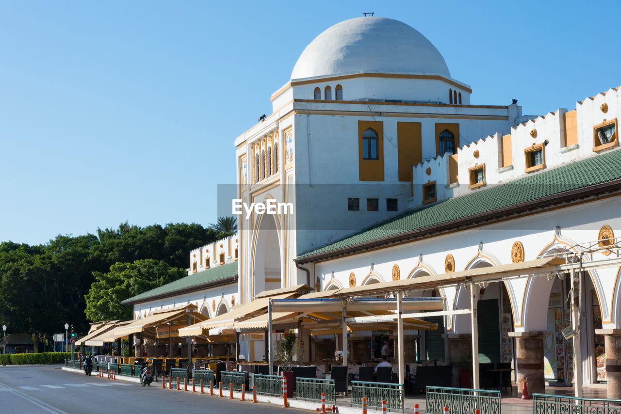 Rhodes town market building on a sunny day, nea agora, mandraki harbour, city of rhodes, greece