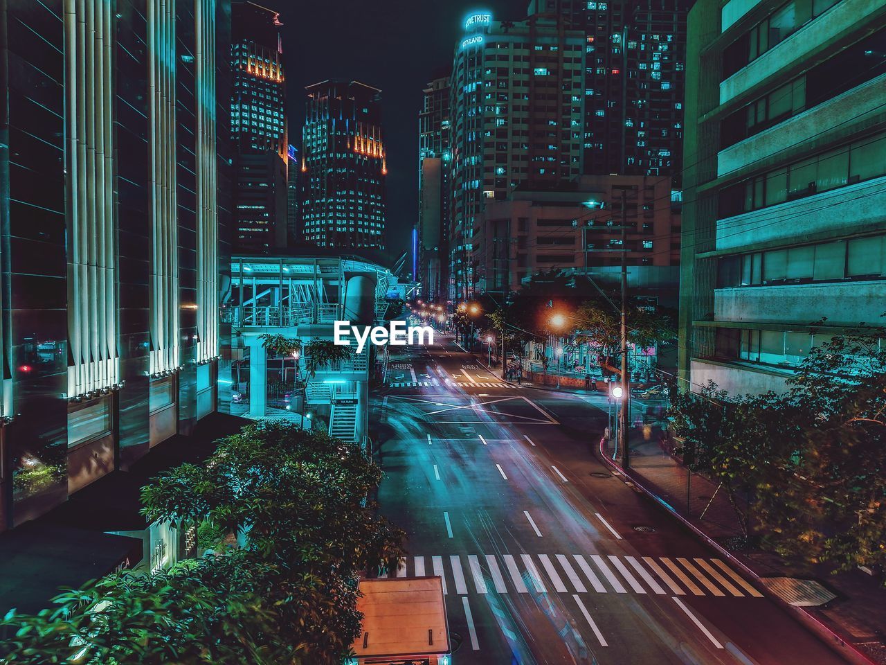 Illuminated city street and buildings at night