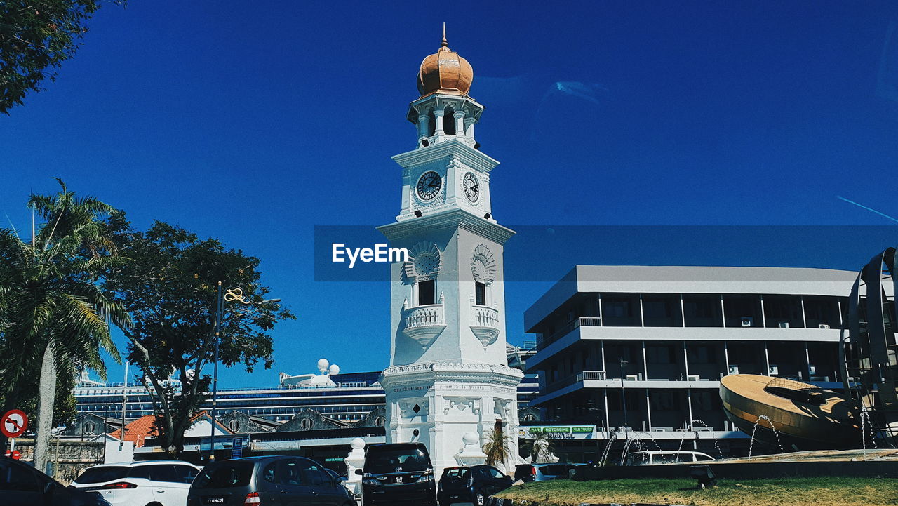 LOW ANGLE VIEW OF BUILDINGS AGAINST CLEAR BLUE SKY