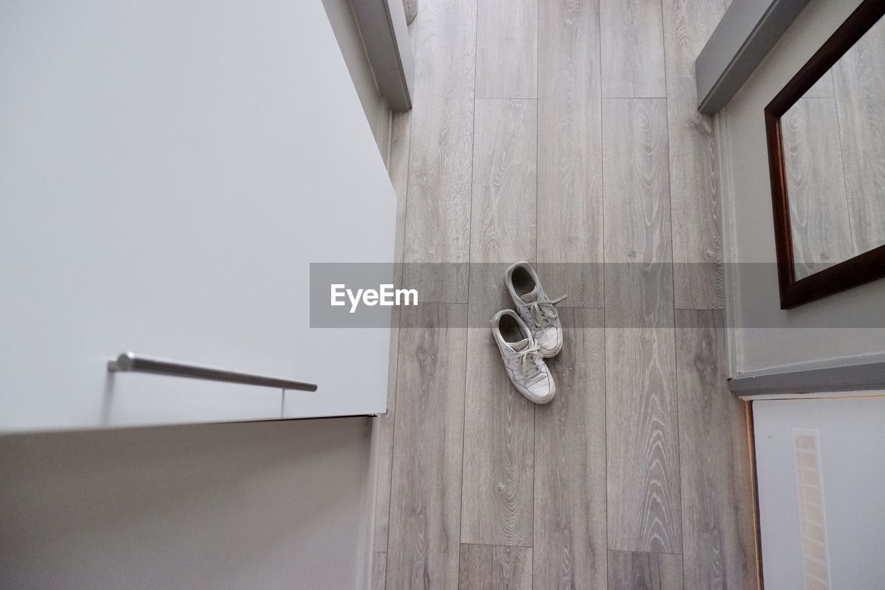 Low angle view of wooden floor with shoes