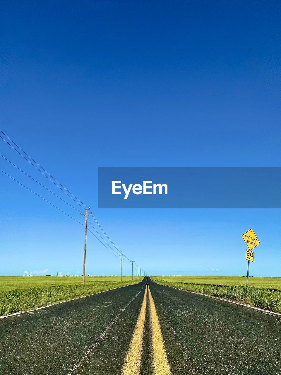 COUNTRY ROAD AGAINST CLEAR SKY