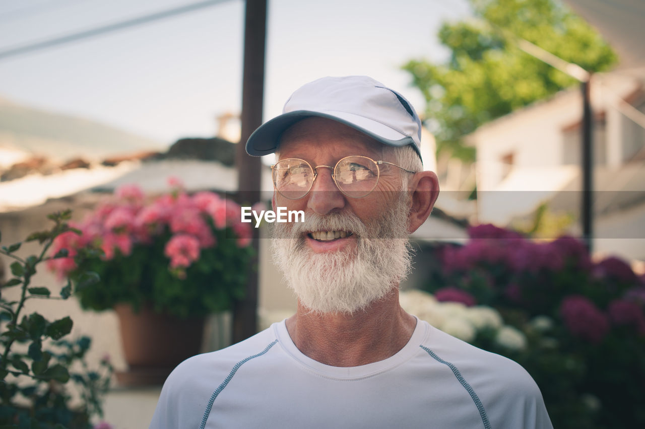 Smiling man looking away in garden