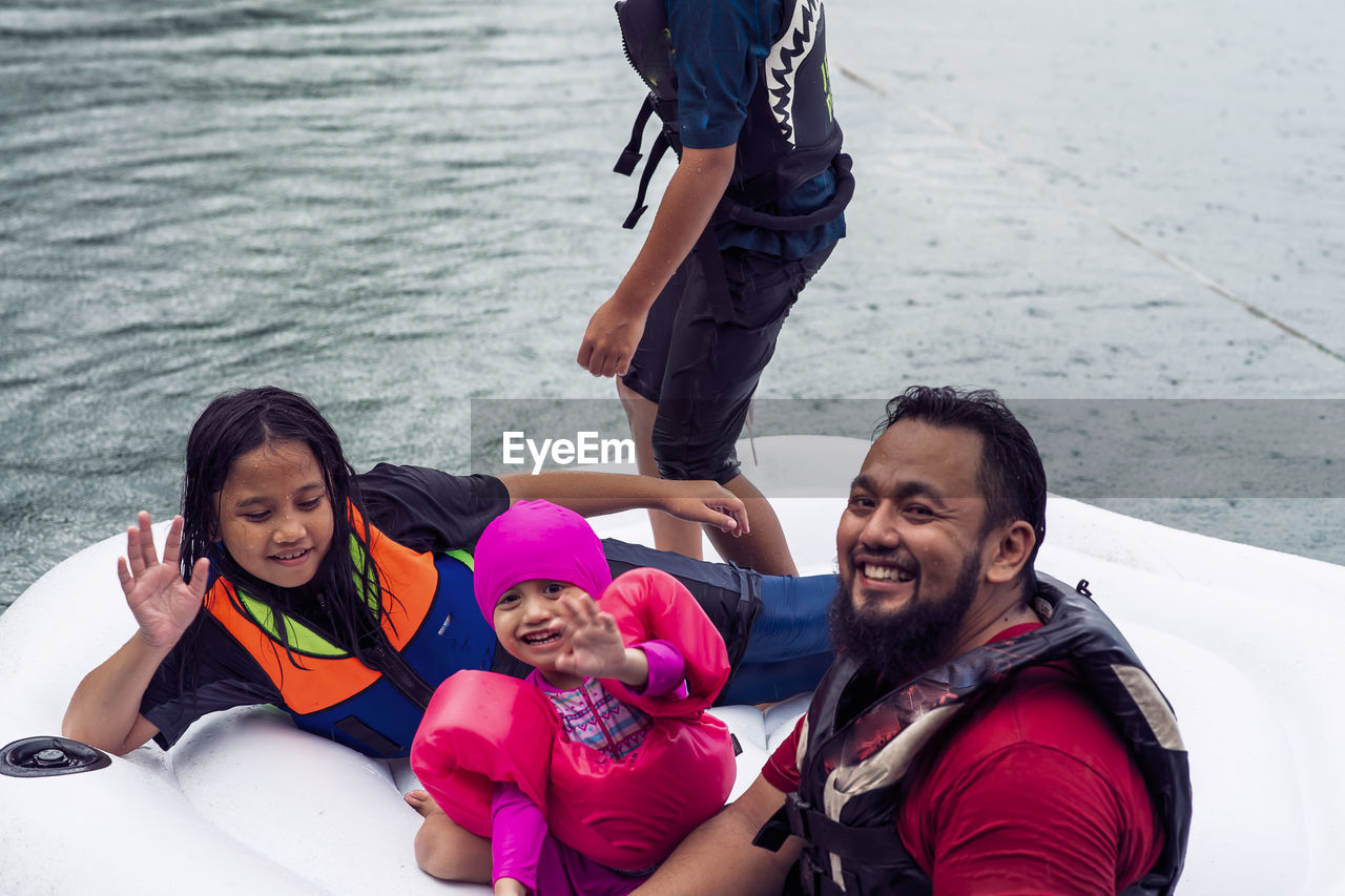 Portrait of happy family enjoying in water