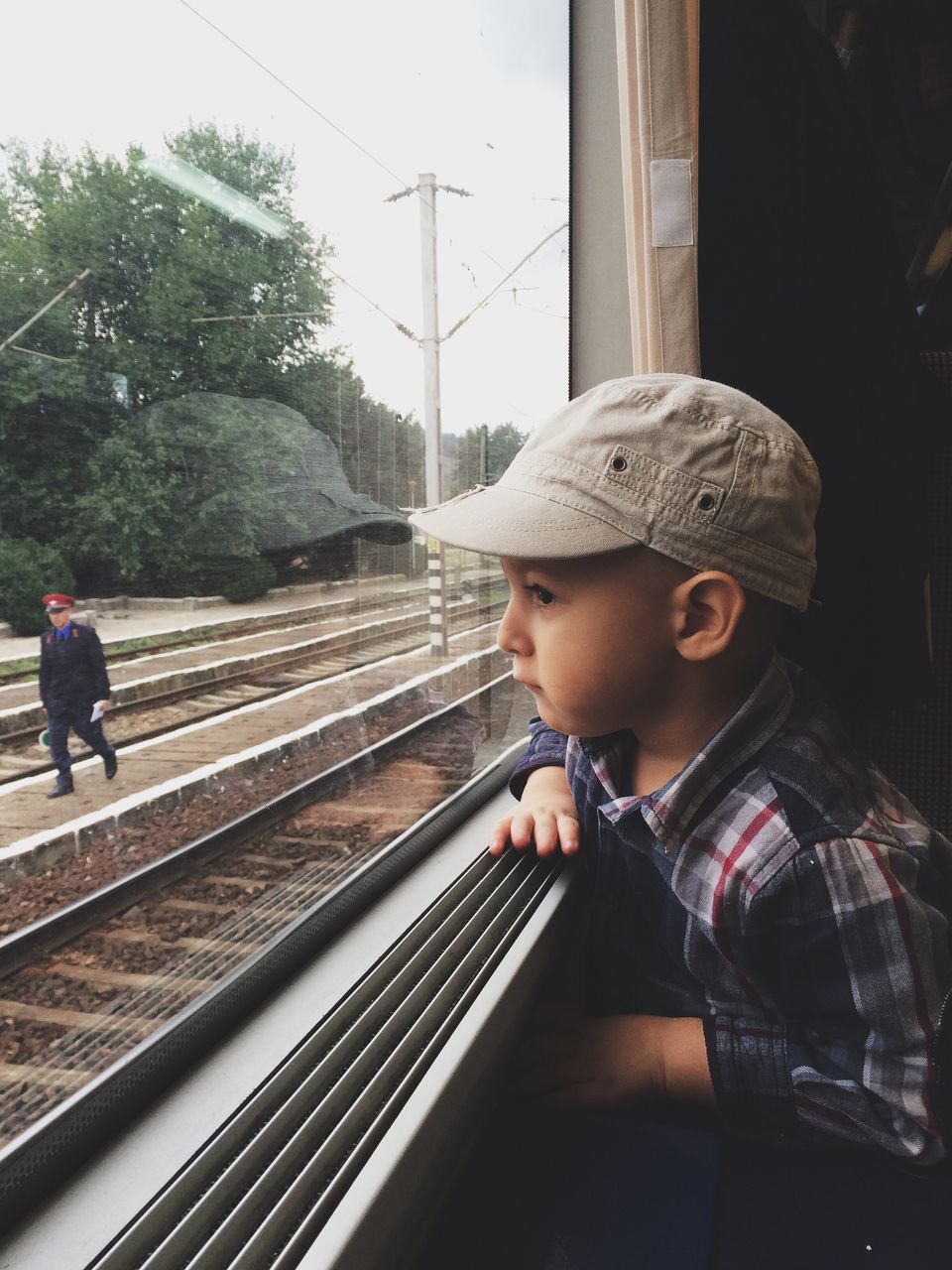 CLOSE-UP OF BOY ON RAILROAD TRACKS