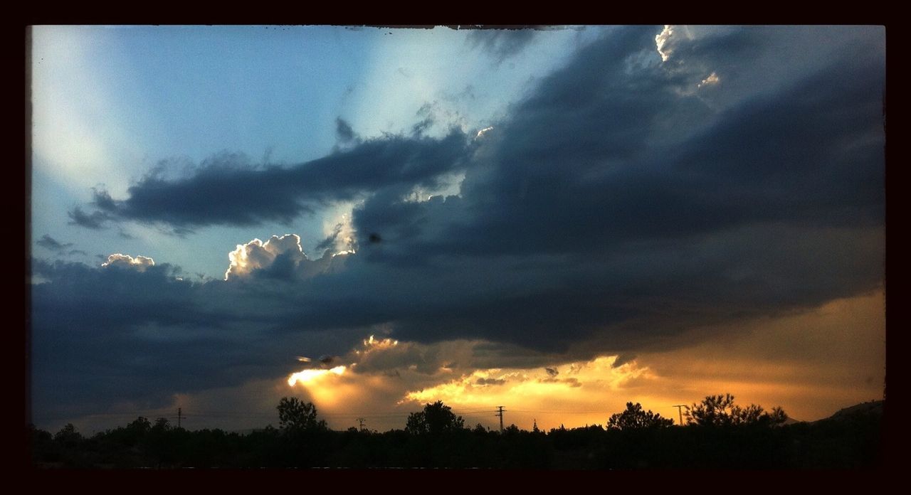 Silhouette landscape against scenic sky at sunset