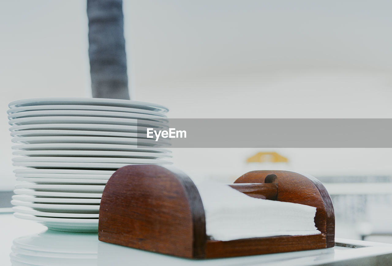Close-up of stack of plates and napkins on table