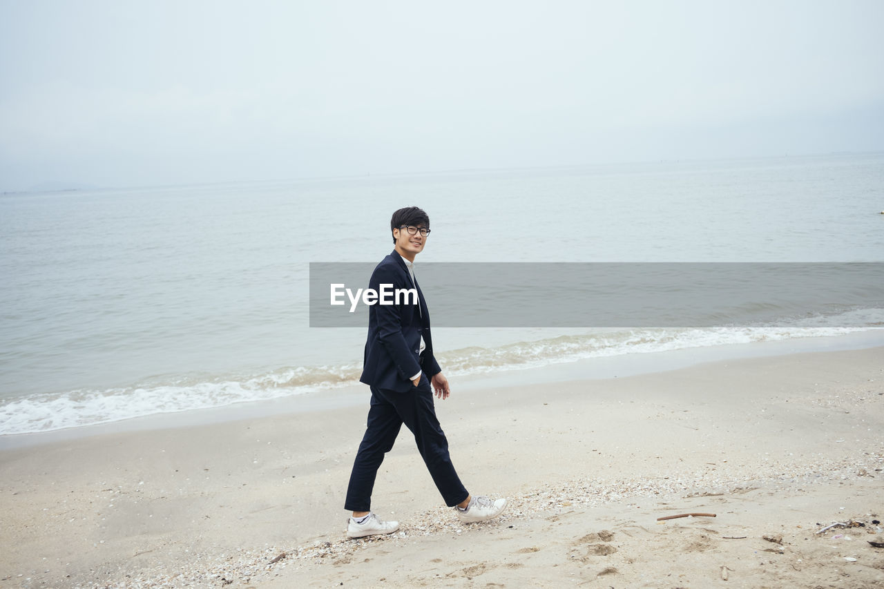 FULL LENGTH OF MAN ON BEACH