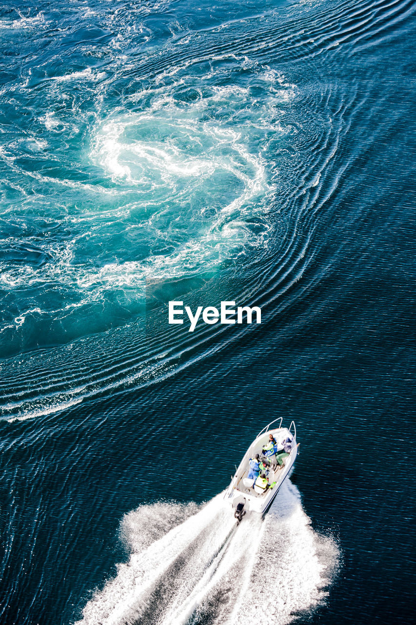 High angle view of people traveling in yacht on sea