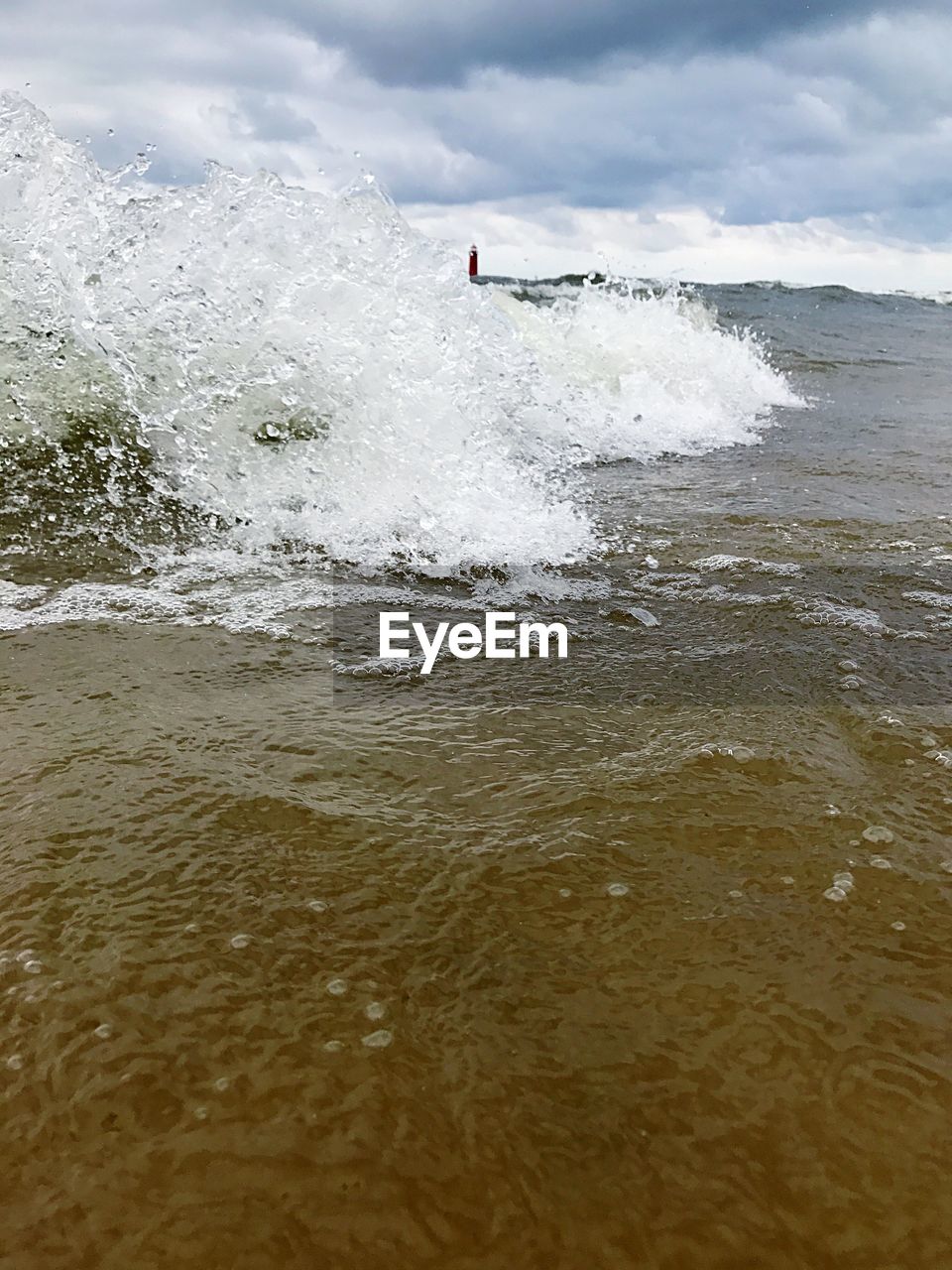 MAN ON BEACH AGAINST SKY