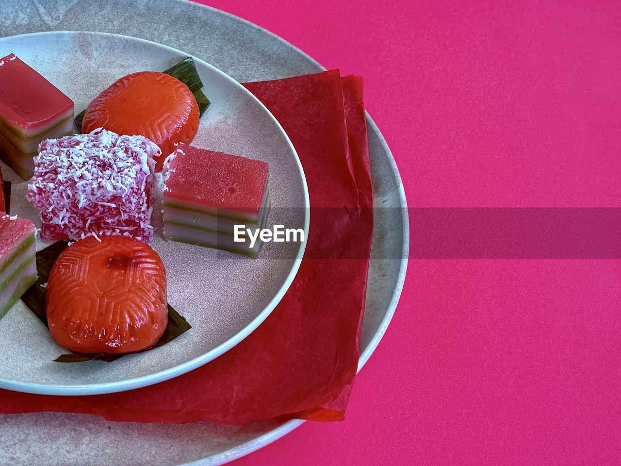 food and drink, food, sweet food, plate, sweet, red, dessert, indoors, no people, freshness, fruit, colored background, still life, studio shot, produce, pink, temptation, unhealthy eating, high angle view, table