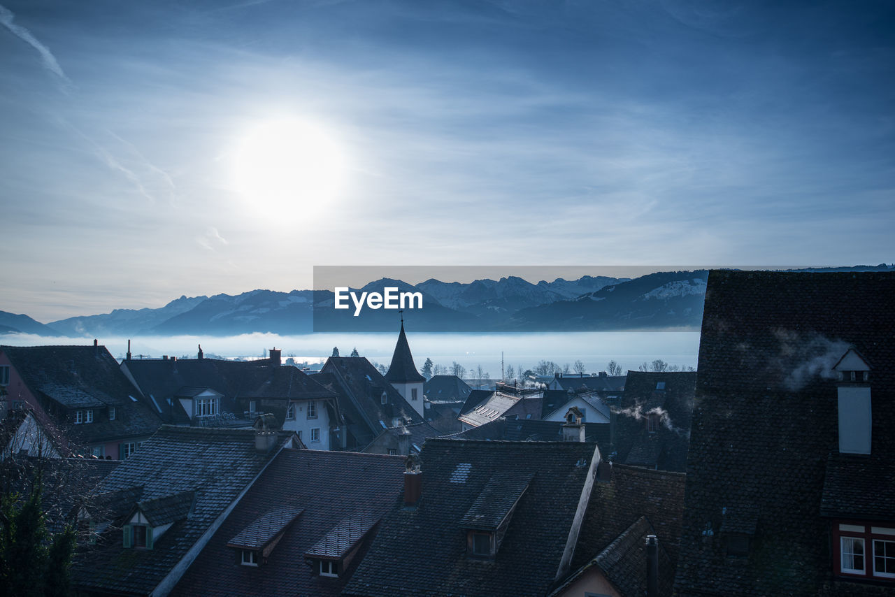 View of cityscape against cloudy sky