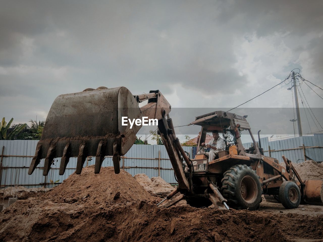 Man in bulldozer working at construction site