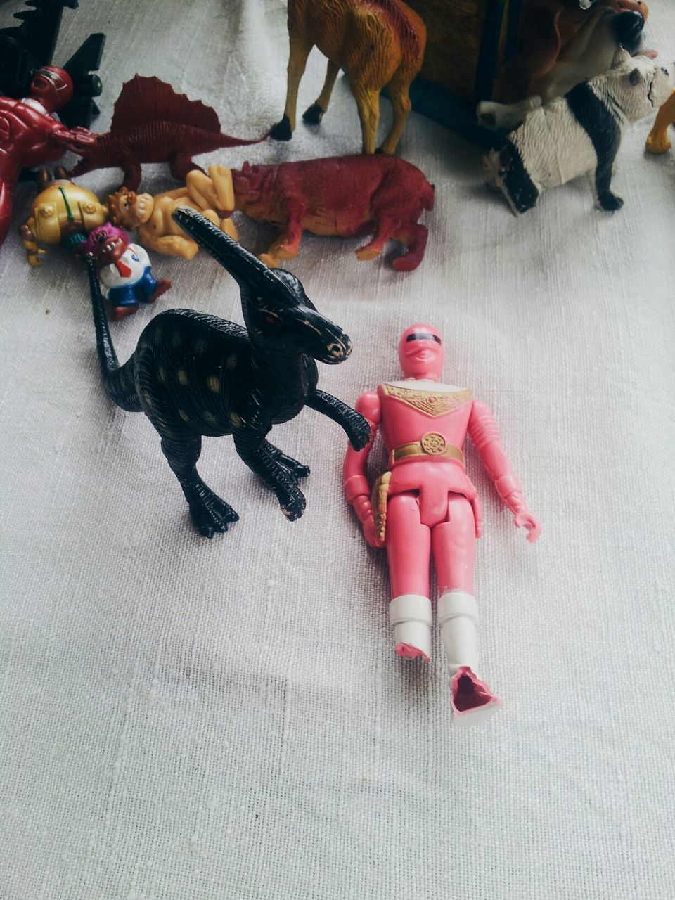 High angle view of plastic toys on bed