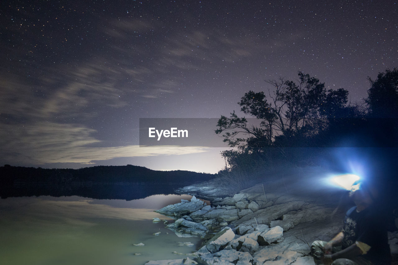 SCENIC VIEW OF TREES AGAINST SKY DURING NIGHT