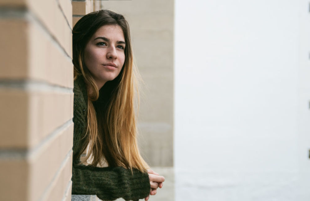 PORTRAIT OF YOUNG WOMAN WITH EYES CLOSED