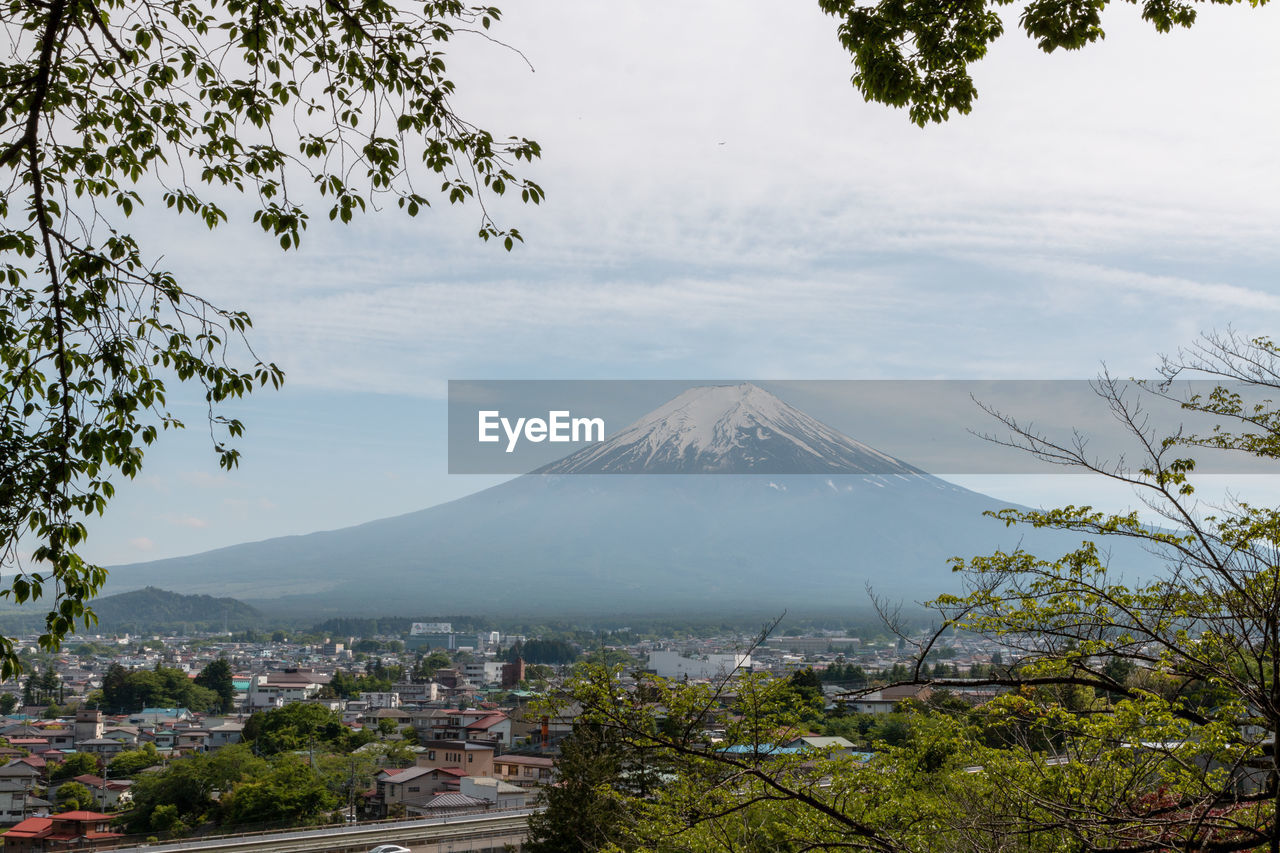 mountain, volcano, nature, tree, plant, travel destinations, landscape, sky, beauty in nature, environment, architecture, city, travel, scenics - nature, no people, tourism, land, cloud, morning, outdoors, mountain peak, built structure, building exterior, fog, rural area, volcanic landscape, culture, day, flower, water, building, leaf, cityscape, tranquility