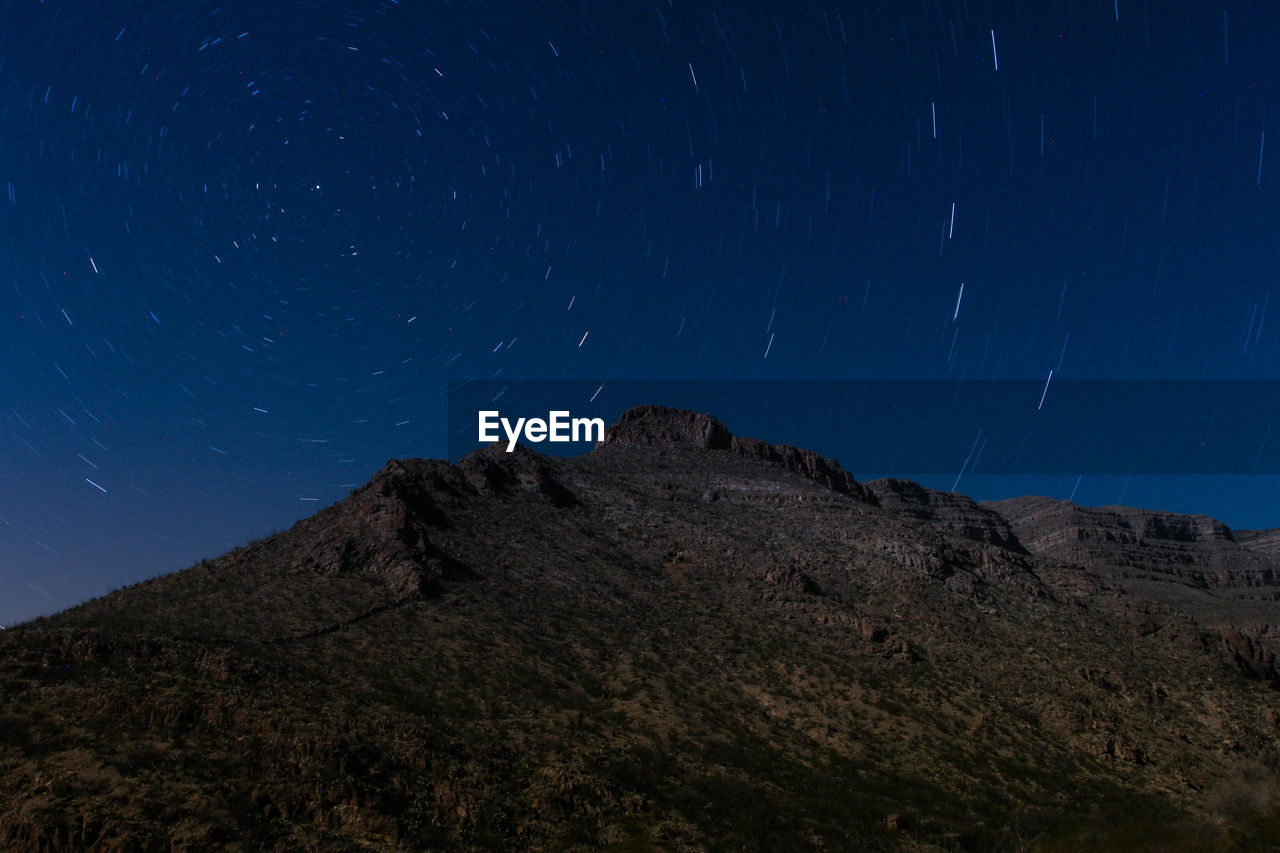 Low angle view of mountain against sky at night