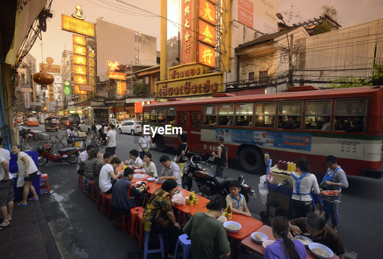 People having snacks at sidewalk cafe