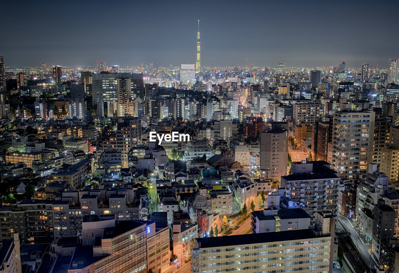 High angle view of city lit up at night