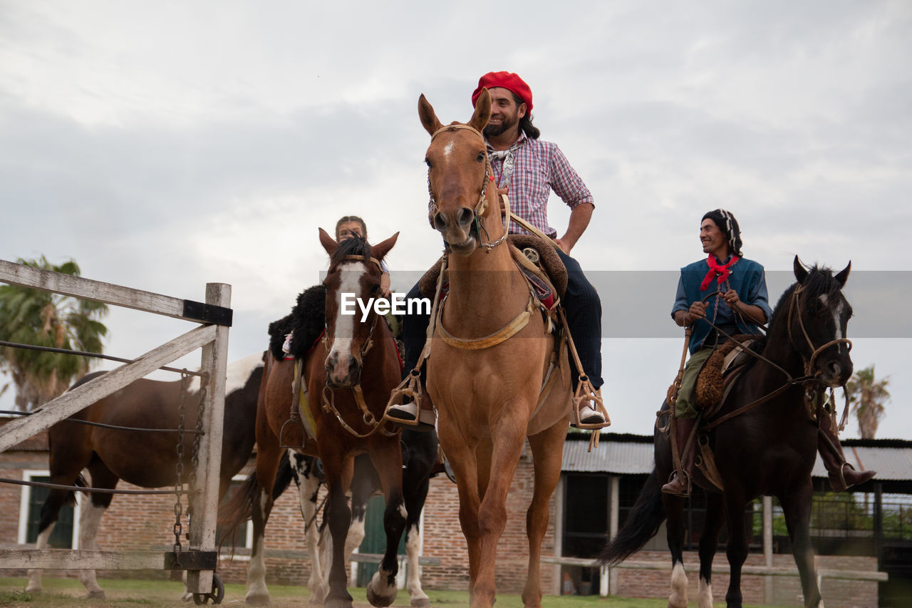 Family riding horses in south america