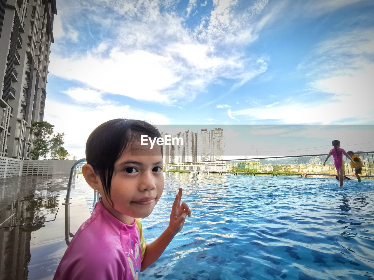 PORTRAIT OF GIRL IN SWIMMING POOL