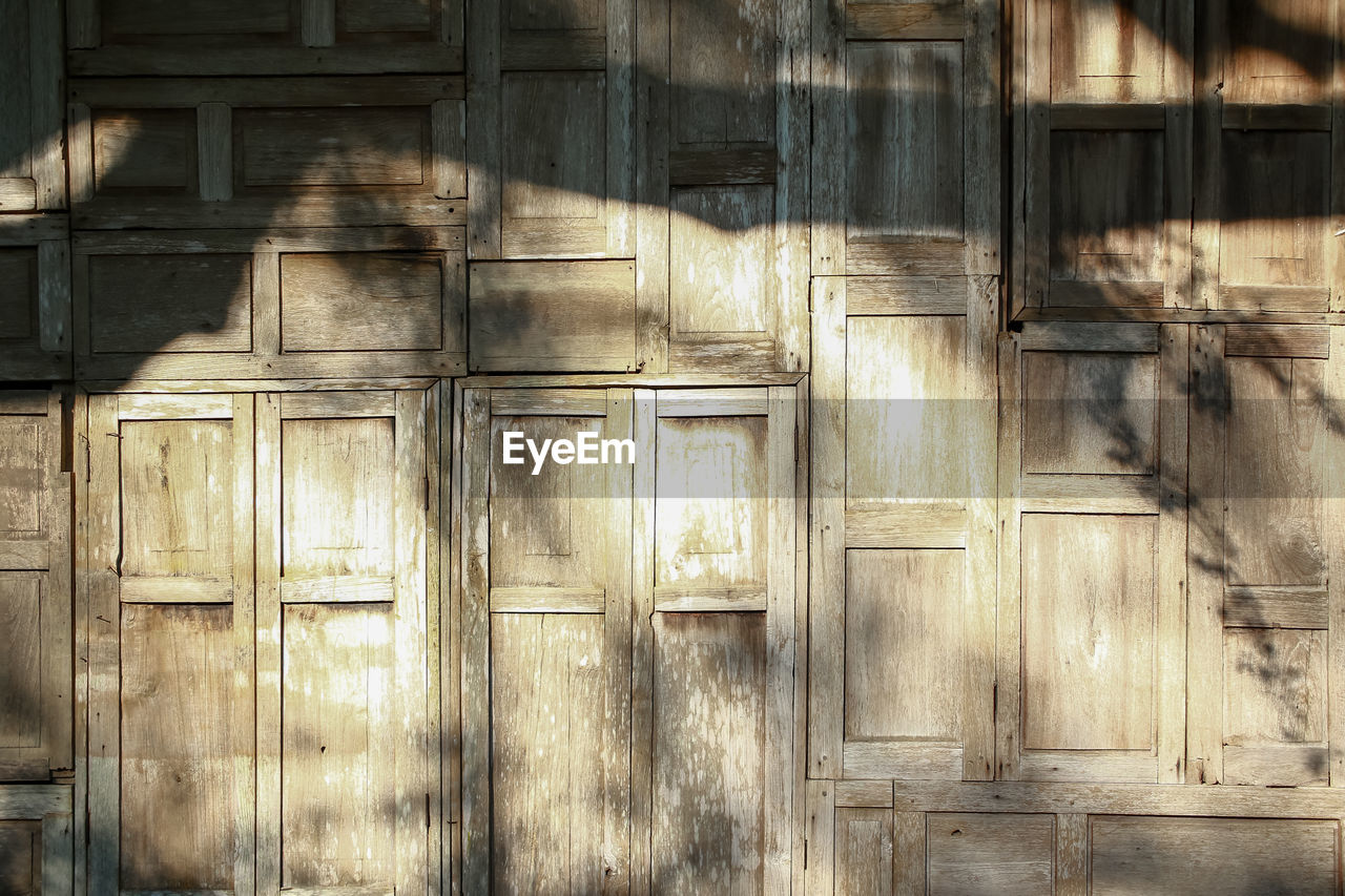 wood, architecture, built structure, no people, door, building exterior, day, building, entrance, wall, old, full frame, backgrounds, closed, ancient history, weathered, outdoors, pattern, wall - building feature, house, sunlight, protection, security, facade, window, abandoned