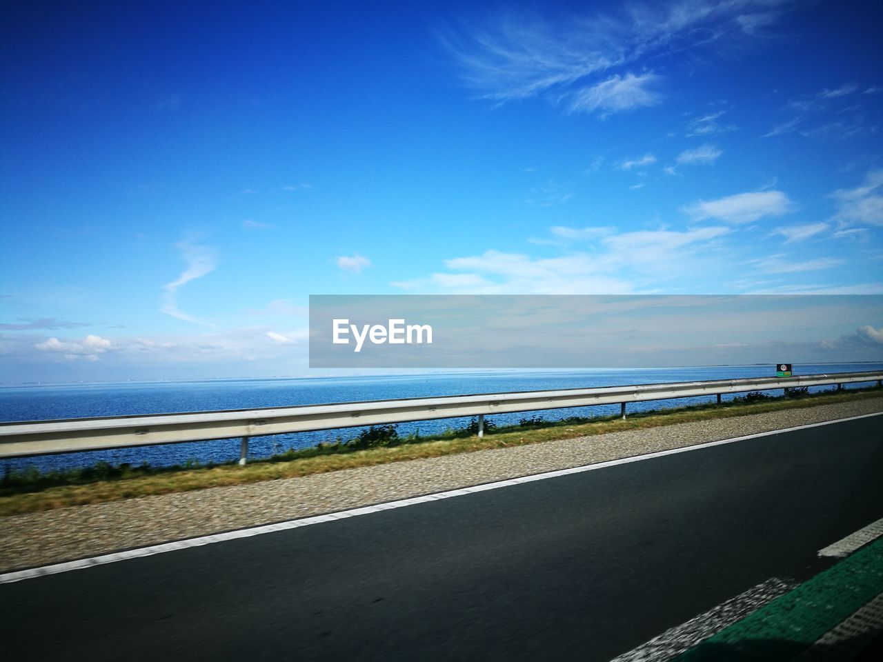 View of empty beach against blue sky