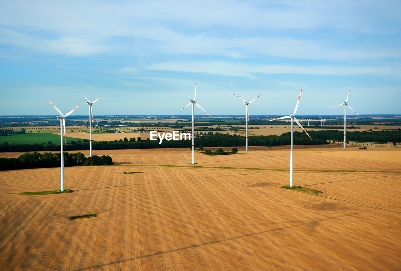 Windmills against sky