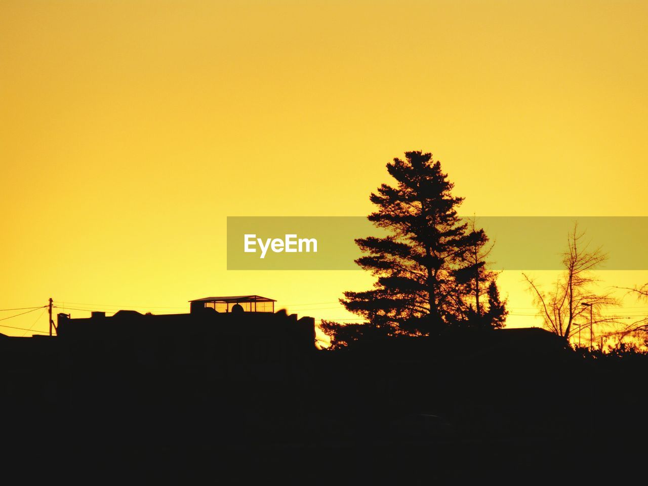 SILHOUETTE BUILT STRUCTURES AGAINST CLEAR SKY DURING SUNSET