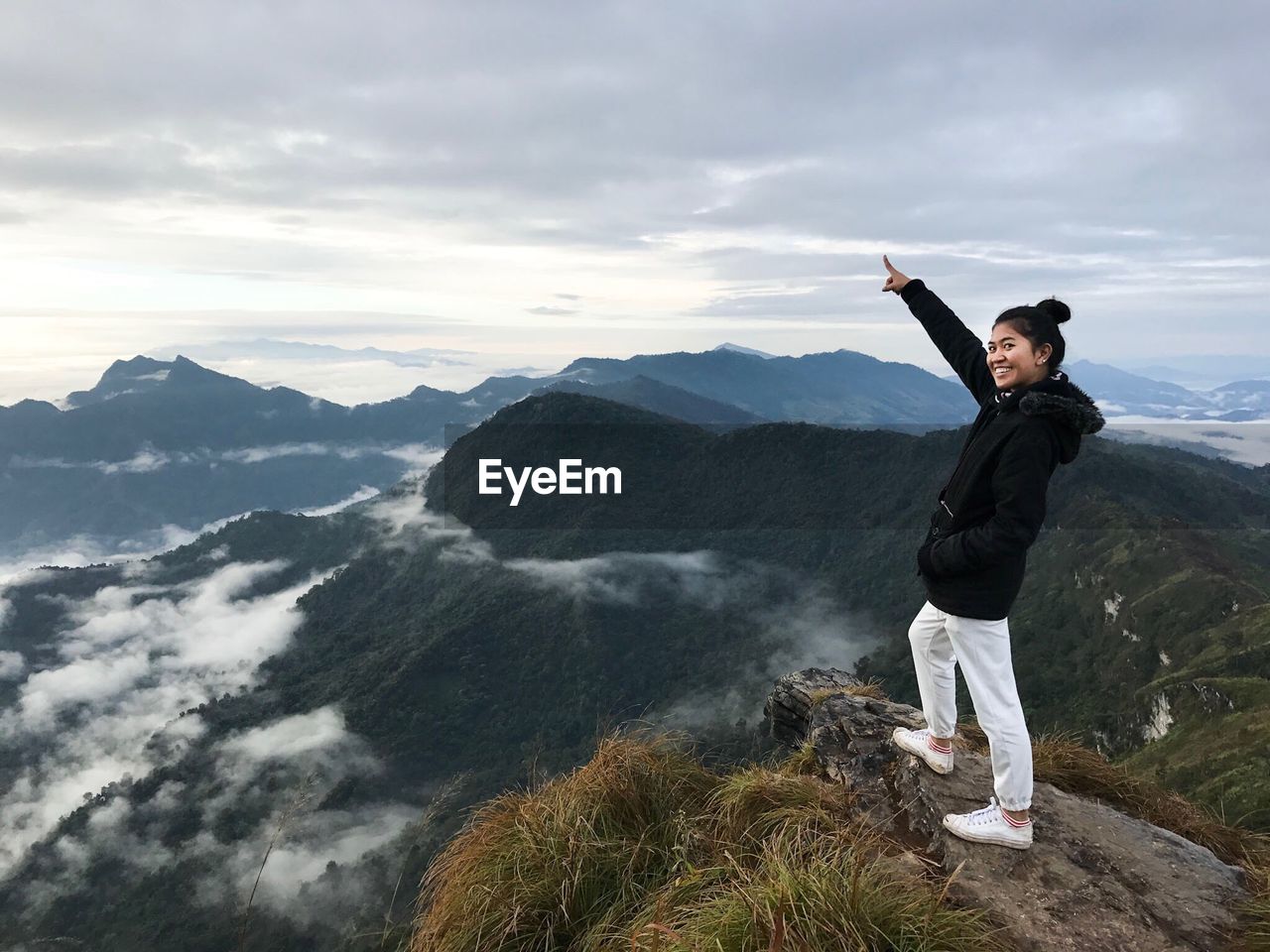 MAN STANDING ON MOUNTAIN