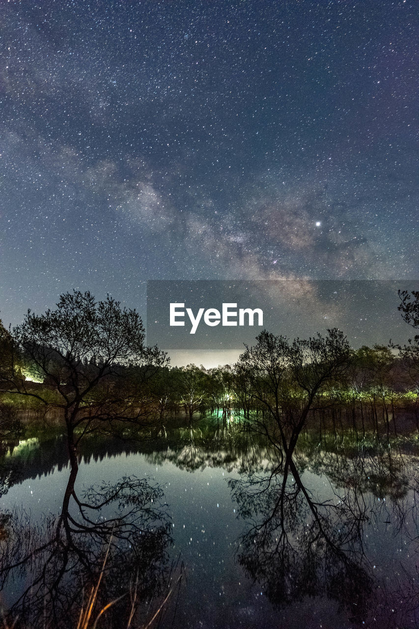 SCENIC VIEW OF LAKE AGAINST STAR FIELD