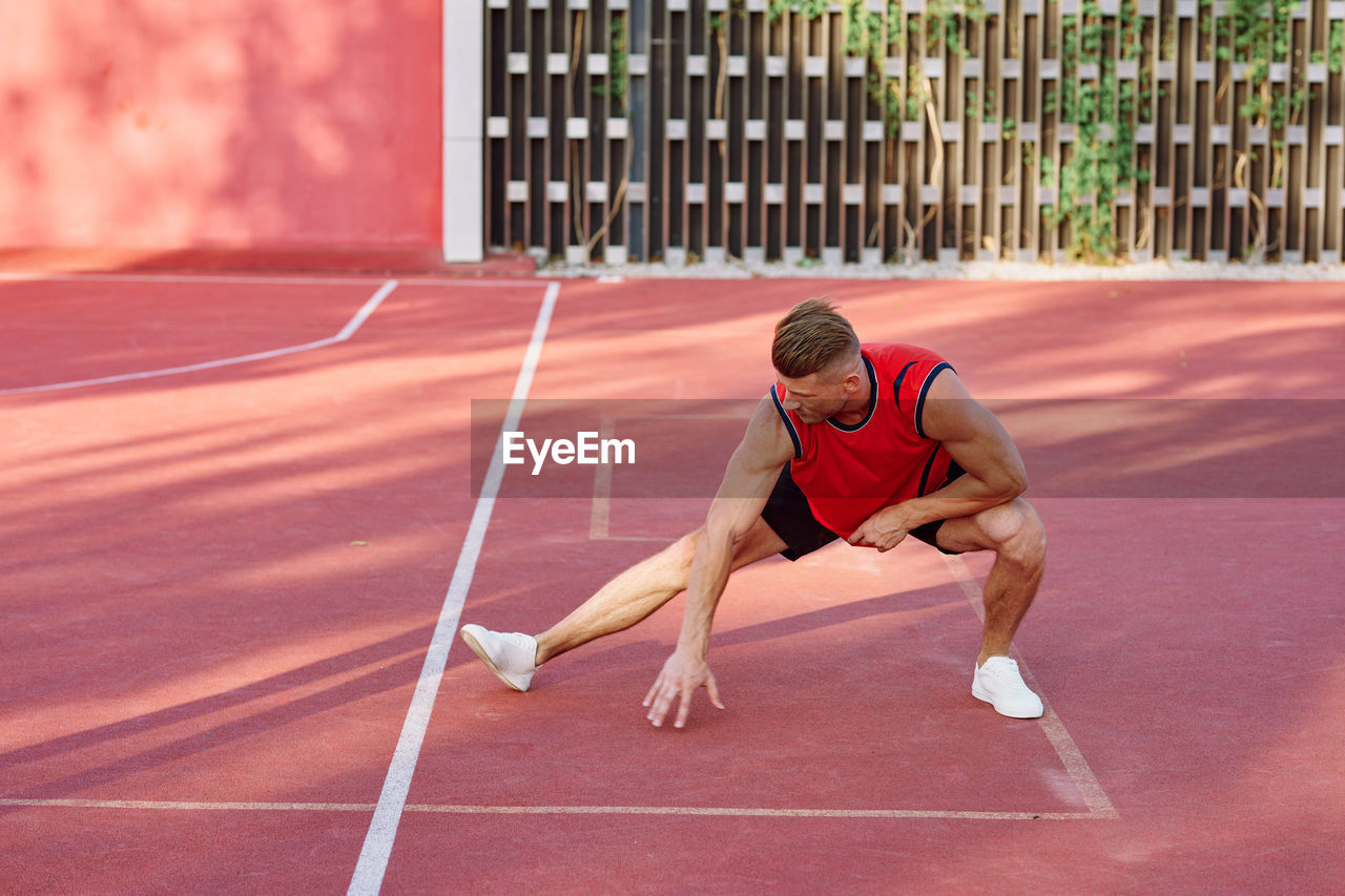 FULL LENGTH OF YOUNG MAN RUNNING ON CARPET