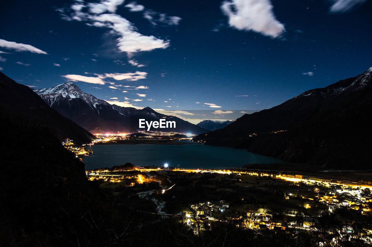 Scenic view of illuminated mountains against sky at night