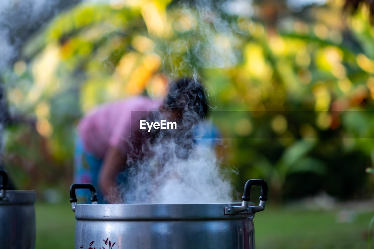 Midsection of woman preparing food in yard