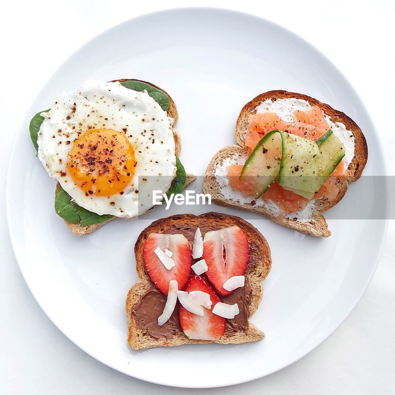 High angle view of breakfast in plate over white background