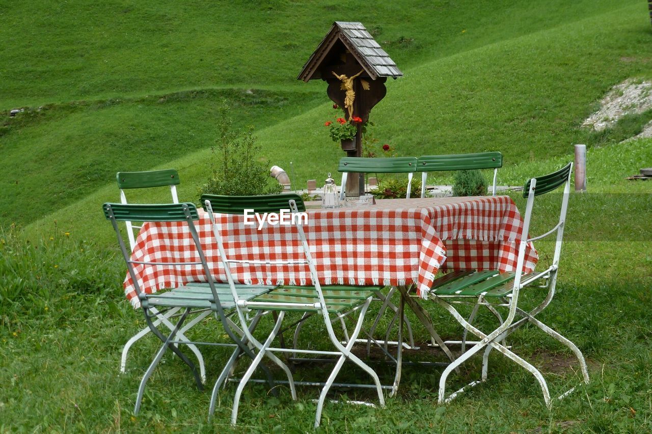 Chairs and table on grassy field