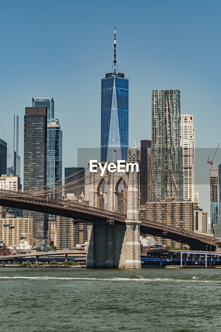 architecture, built structure, city, building exterior, skyline, landmark, skyscraper, office building exterior, building, urban skyline, sky, landscape, cityscape, water, travel destinations, bridge, urban area, transportation, downtown, travel, nature, downtown district, river, waterfront, office, tower, clear sky, tower block, no people, tourism, residential district, city life, outdoors, blue, business, metropolitan area, financial district, day, business finance and industry, nautical vessel, vehicle