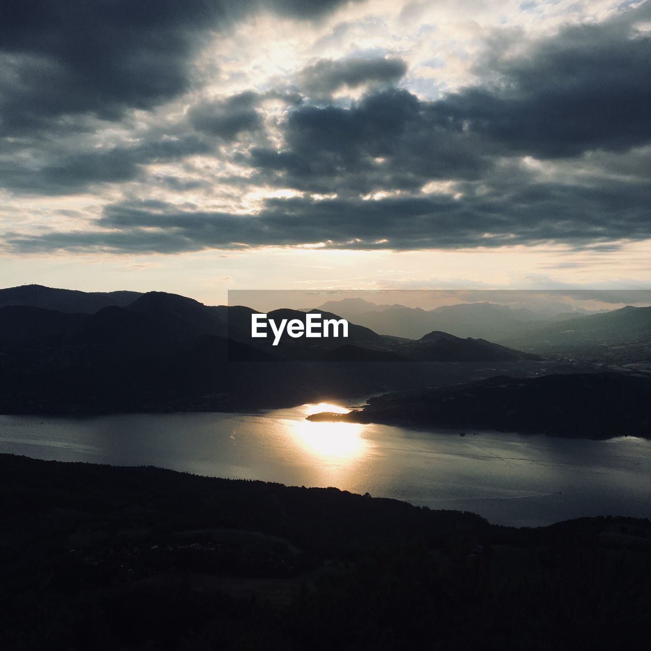 Scenic view of lake against sky during sunset