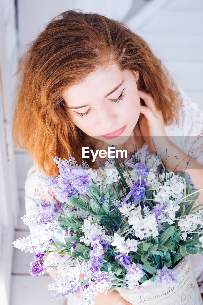 High angle view of woman holding flowers