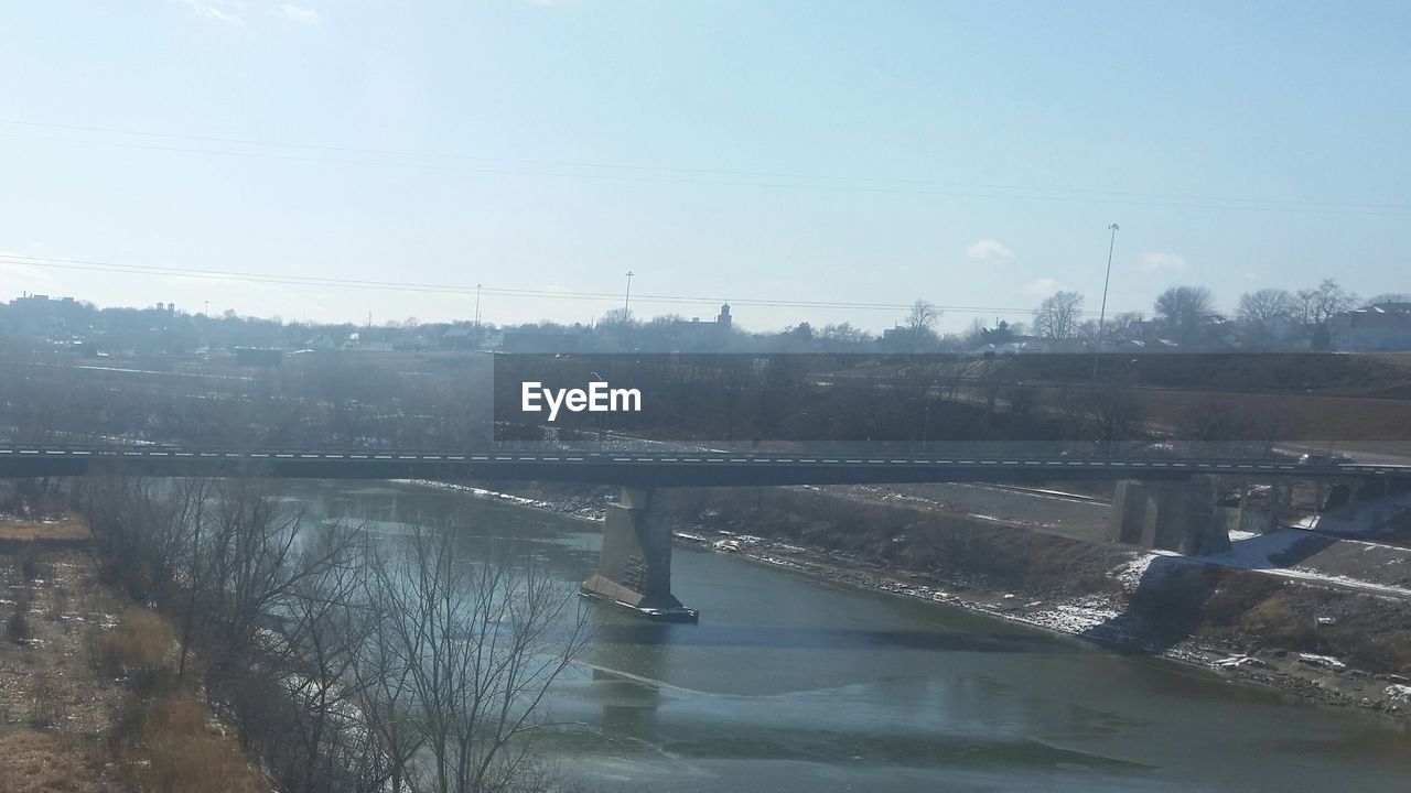 VIEW OF RIVER WITH BUILDINGS IN BACKGROUND