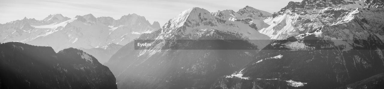 Panoramic view of snowcapped mountains against sky