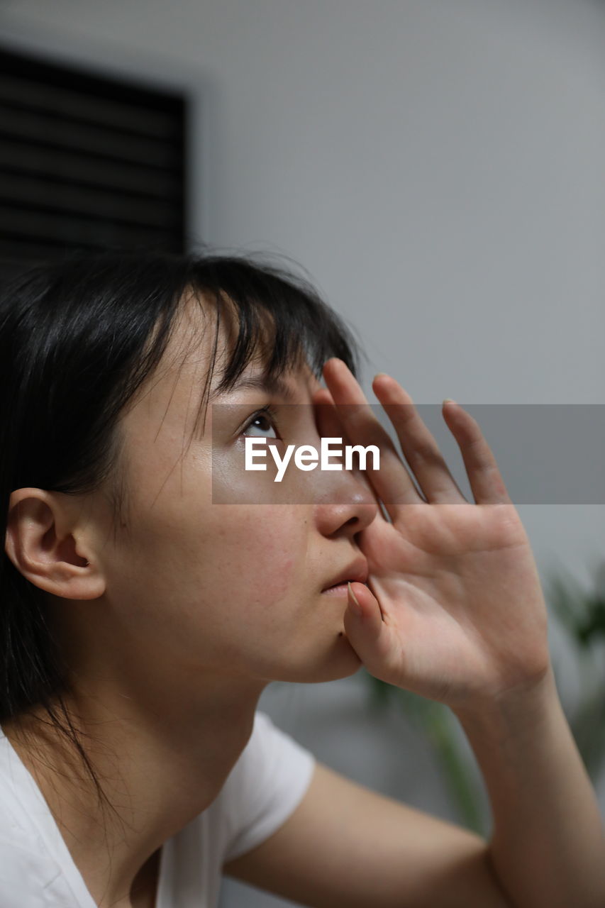 Close-up of thoughtful woman at home