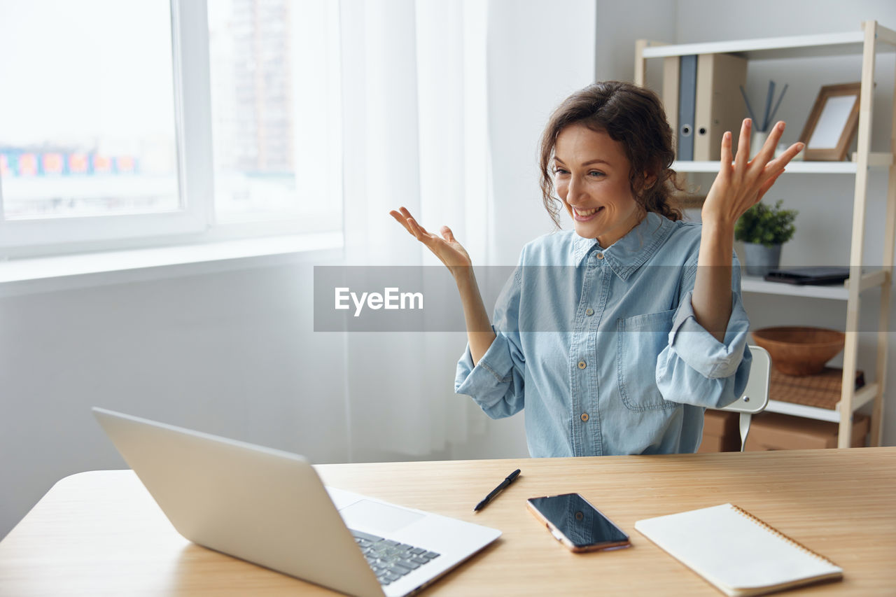 Young woman using laptop at office